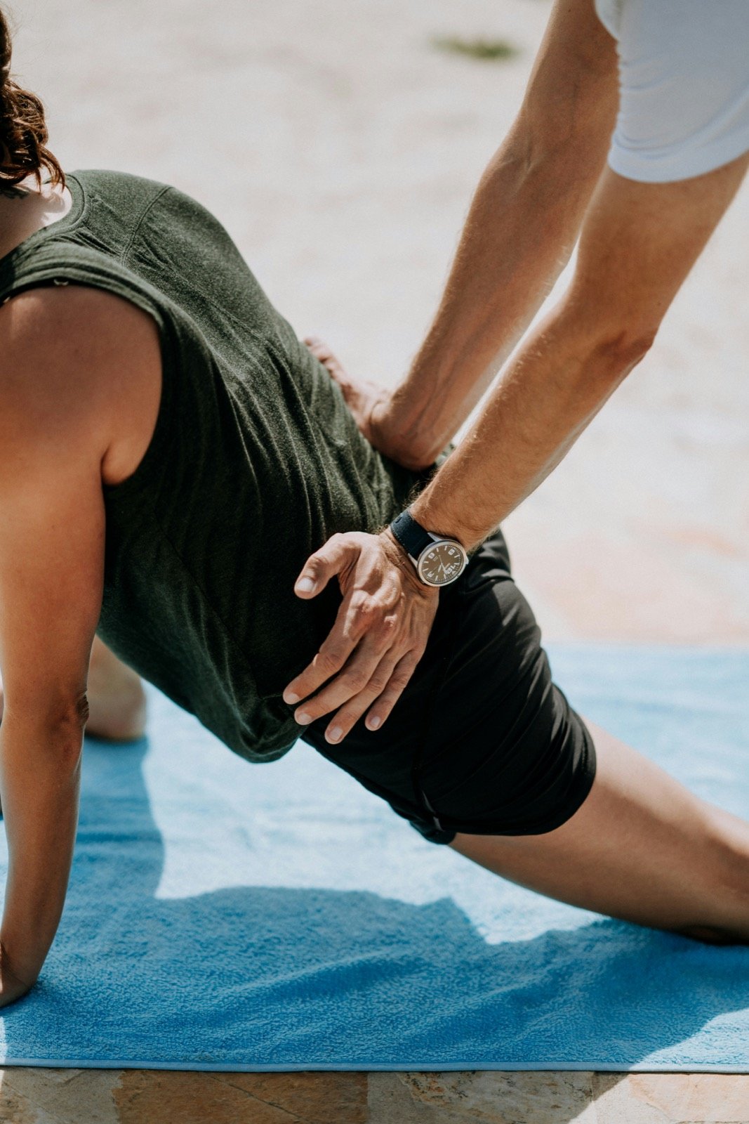 A guided hip stretch on a blue mat
