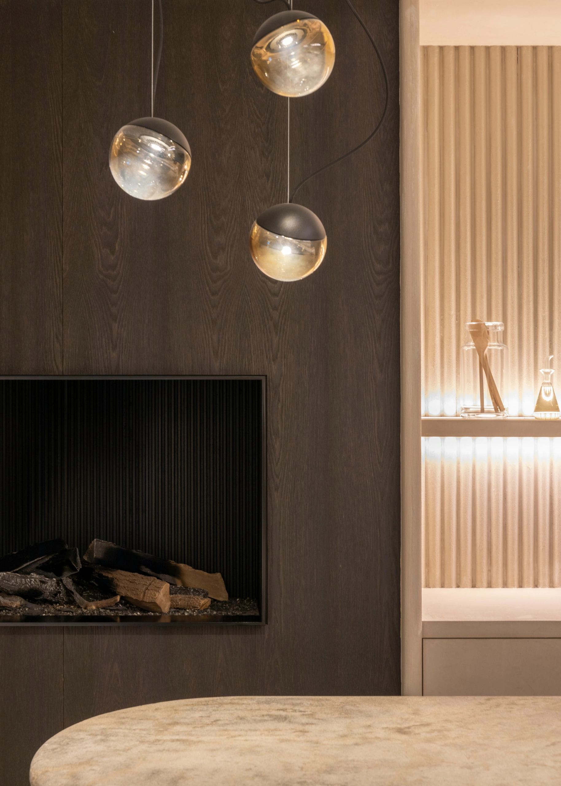 Curated staging environment with fluted wall, dark oak, and warm ambient light